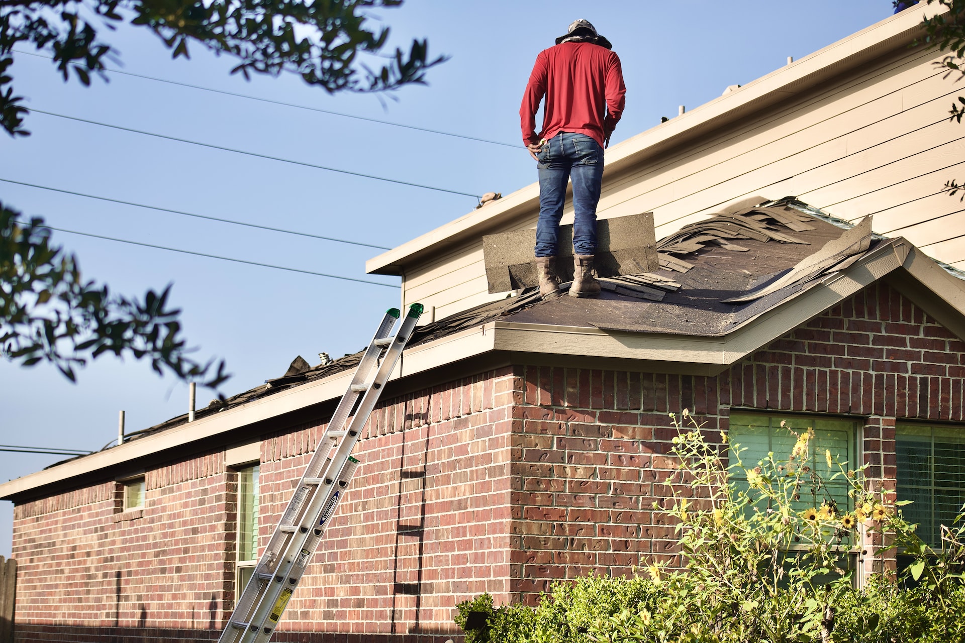 Man on a damaged roof.