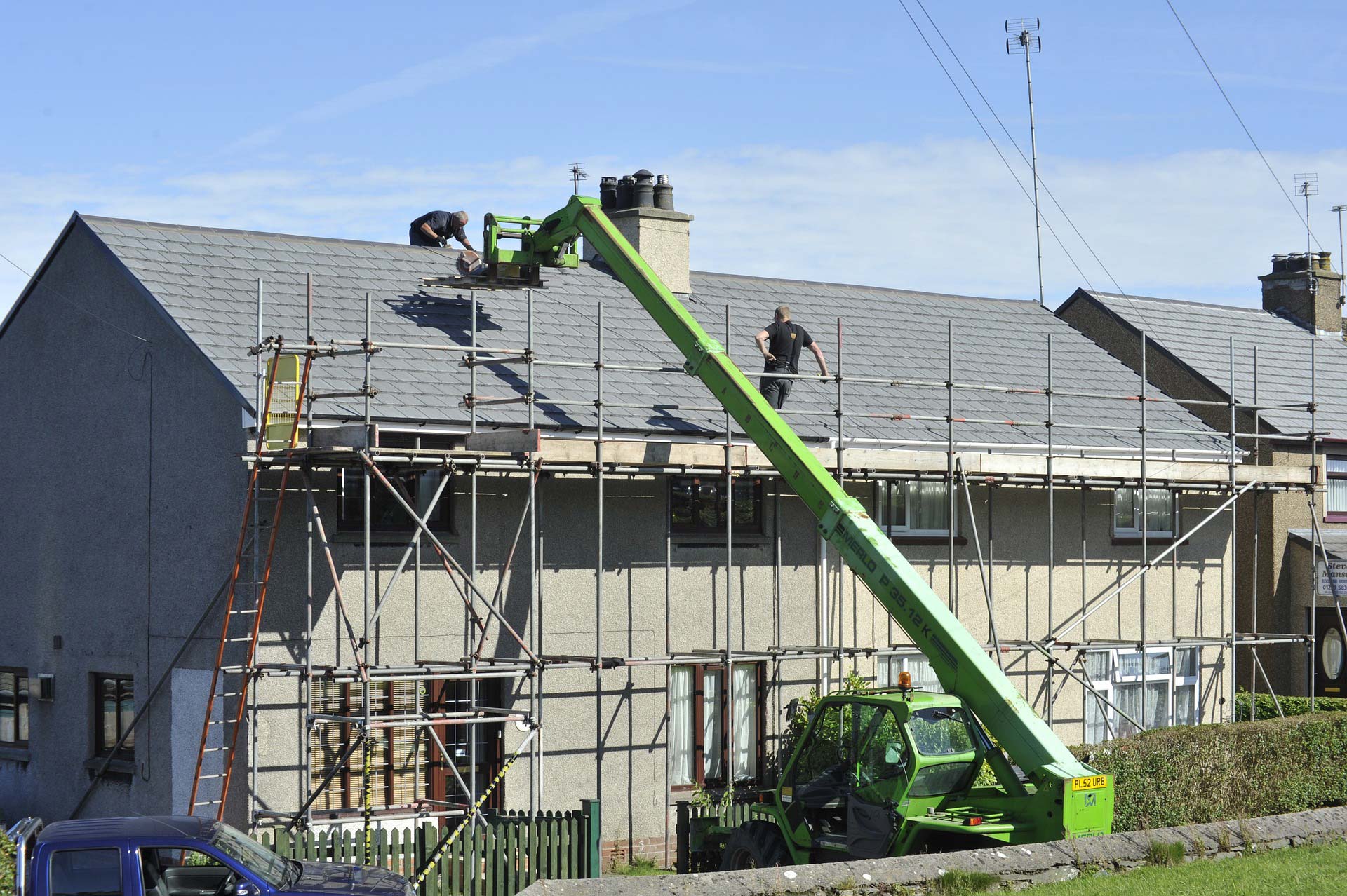 a team of workers repairing a roof
