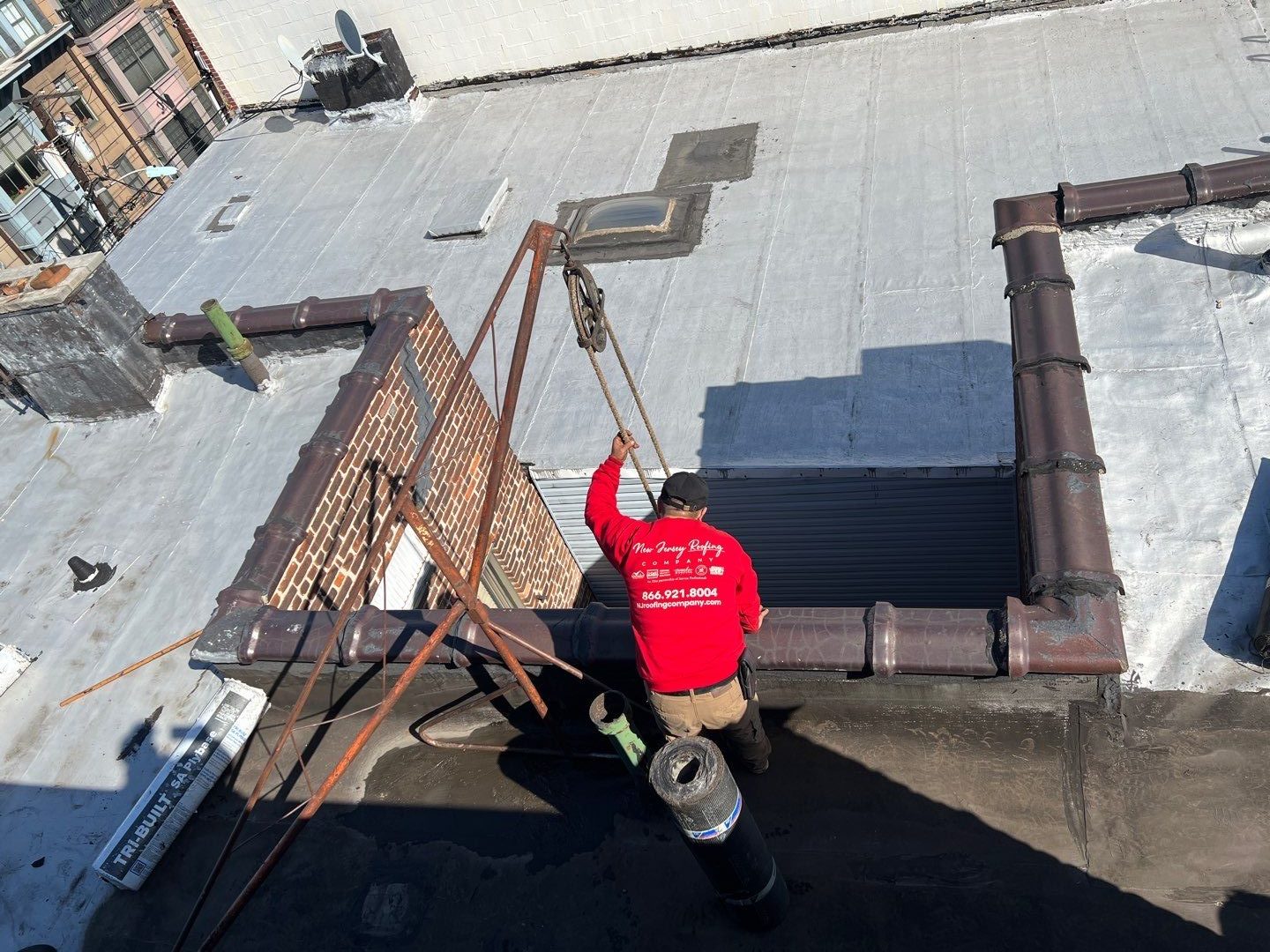 a new jersey roofing contractor is working on a flat roof